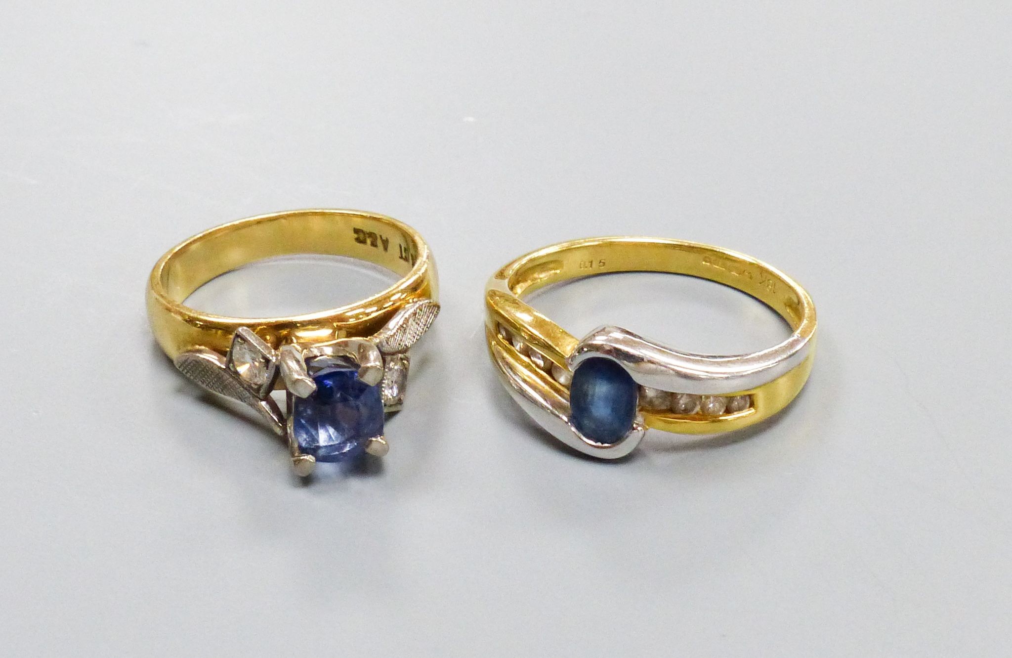 Two modern 18ct gold, sapphire and diamond set dress rings including three stone sizes I & P, gross weight 10 grams.